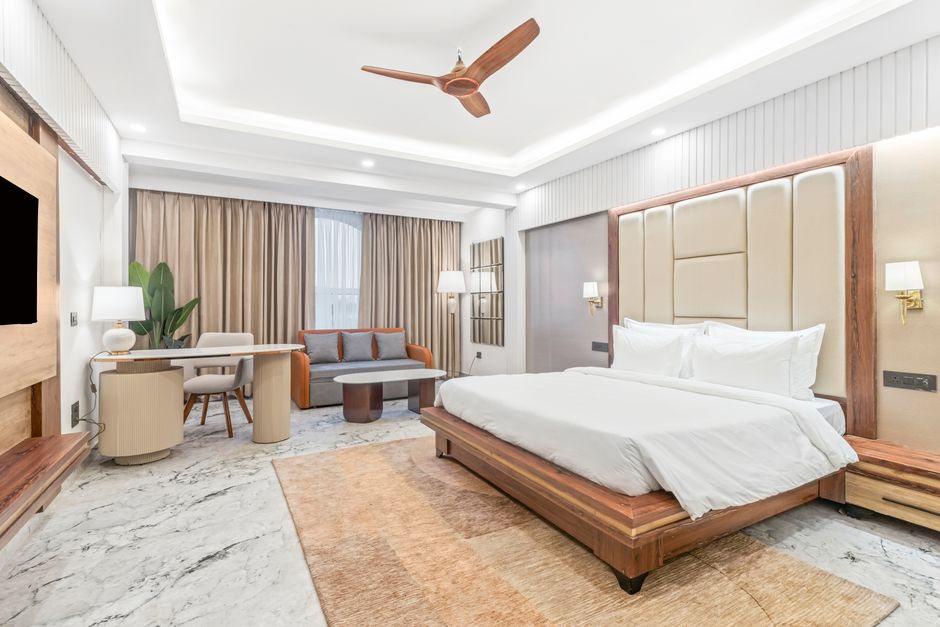 Spacious modern bedroom with elegant furniture, perfect for luxury accommodation settings.
