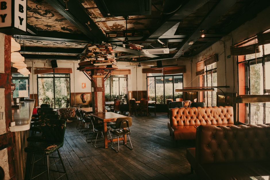 Inviting vintage-style café interior with leather sofas and rustic decor, perfect for relaxed gatherings.