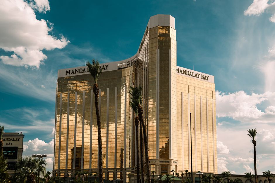 The iconic Mandalay Bay Hotel in Las Vegas shines brightly against a clear blue sky.