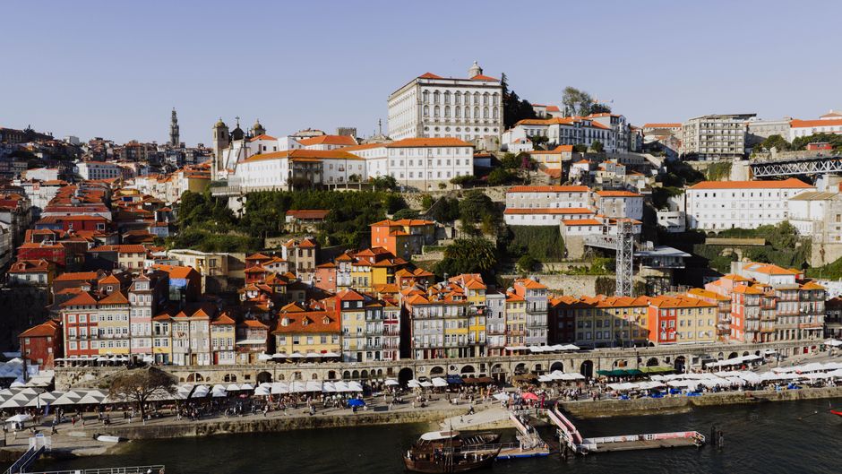 Scenic aerial view of Porto's colorful riverside buildings and historic architecture in Portugal.