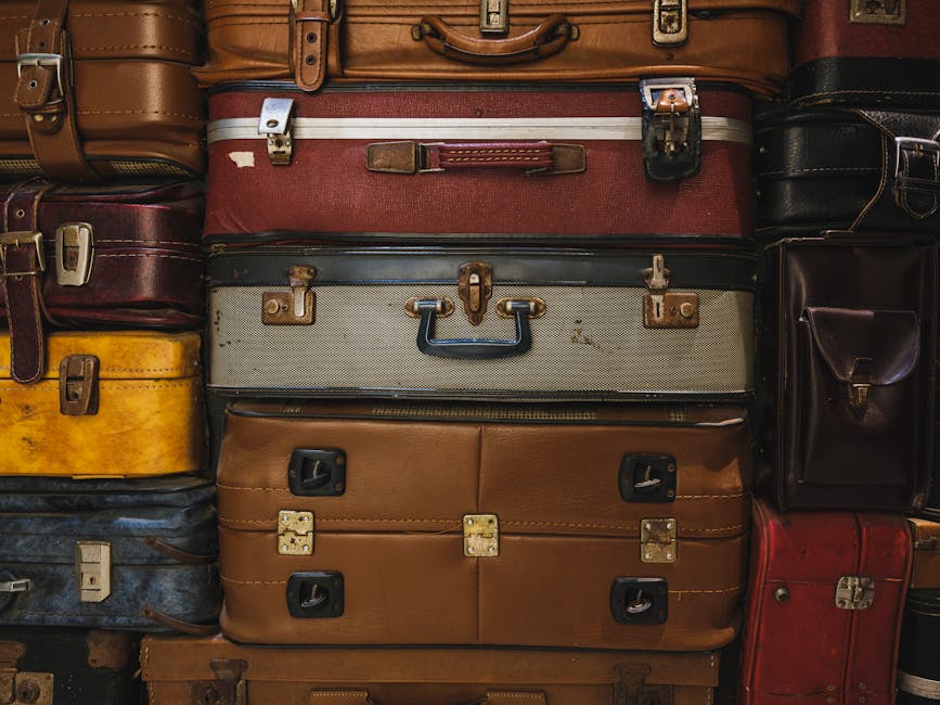 A collection of vintage suitcases stacked together, showcasing retro travel charm.