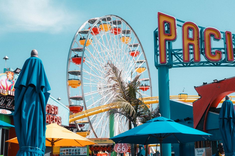 Colorful Ferris wheel and Pacific Park sign at Santa Monica Pier, Los Angeles.