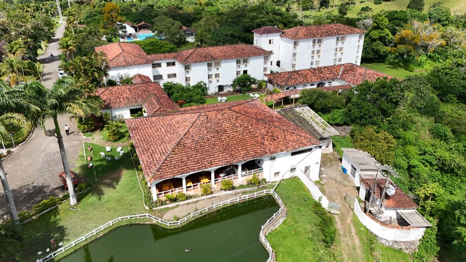 Aerial shot of a historic building with red tile roof surrounded by lush greenery in Moreno, Pernambuco, Brazil.