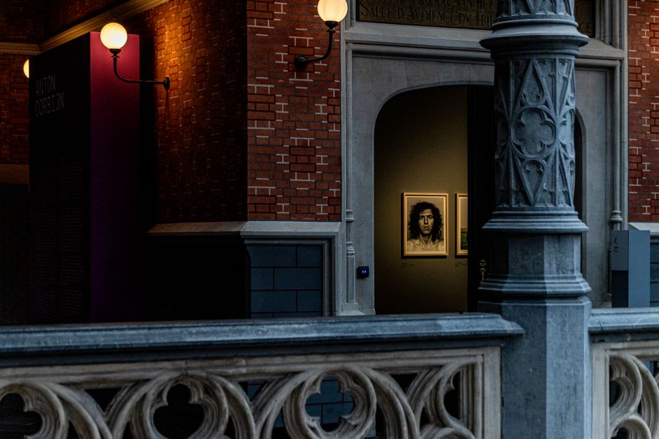 Mysterious art exhibit entrance in a dimly lit museum corridor with architectural details.