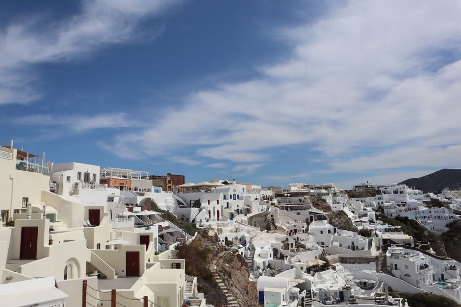 Beautiful white buildings of Santorini under a clear blue sky.