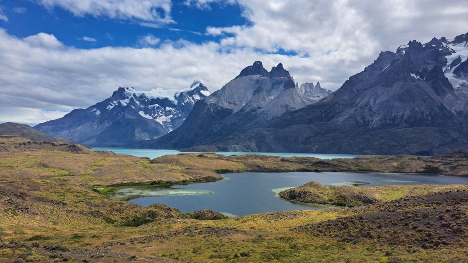 Majestic view of Torres del Paine mountains with tranquil lake in Patagonia, Chile.