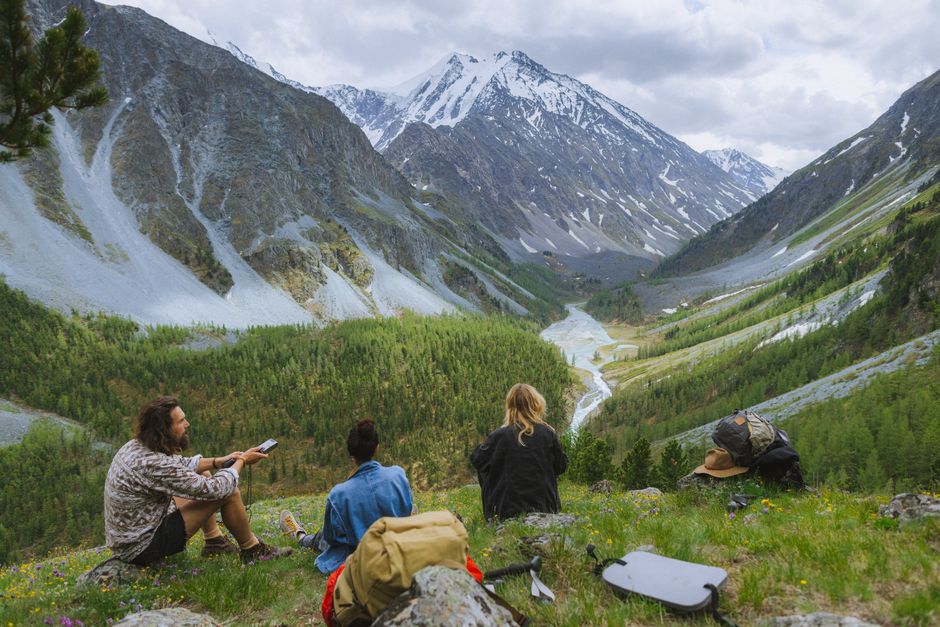 Explore stunning views of the Altai Mountains with hikers enjoying the serene landscape.